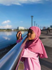 Side view of woman standing in pink water