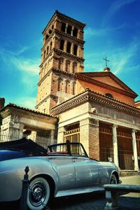 Low angle view of vintage car against blue sky