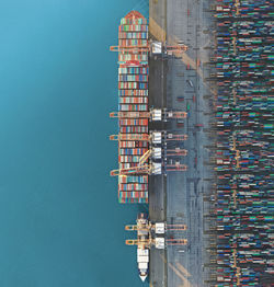 High angle view of commercial dock by sea against building