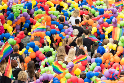 High angle view of people standing by multi colored flowers