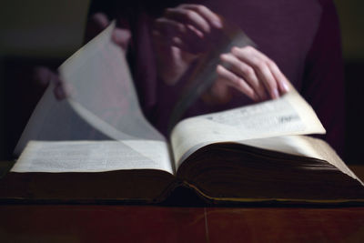 Midsection of woman reading book