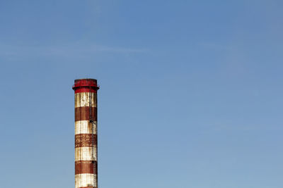 Low angle view of smoke stack against sky