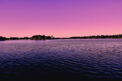 Scenic view of lake against romantic sky at sunset