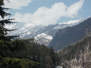 Scenic view of mountains against cloudy sky