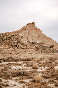 Scenic view of arid landscape against sky