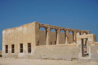 Old ruins of building against blue sky