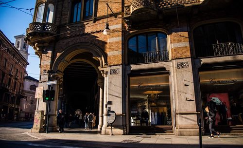 People on street amidst buildings in city