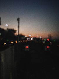 Defocused image of illuminated city against sky at night