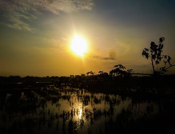 Scenic view of lake against sky during sunset