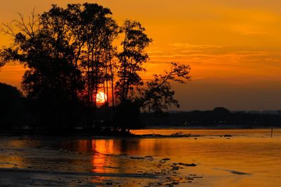 Scenic view of lake against orange sky