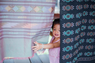 Girl standing by clothesline