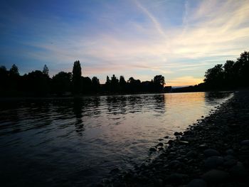 Scenic view of lake against sky at sunset