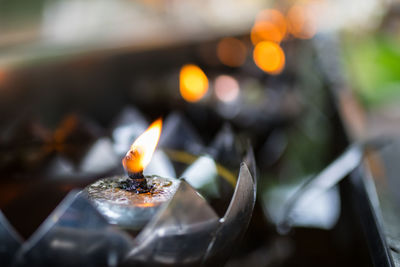 Close-up of burning candle in temple