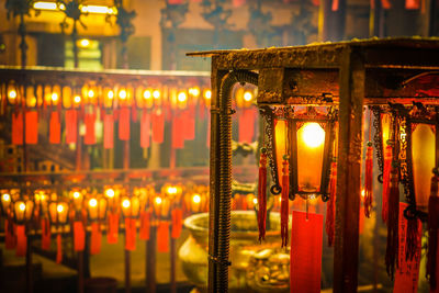 Illuminated lanterns hanging in building at night