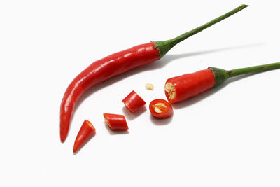 Close-up of red chili pepper against white background