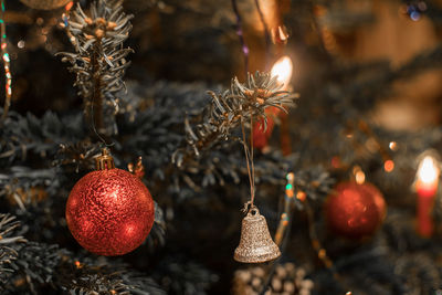 Atmospheric christmas balls and whistle hanging in christmas tree