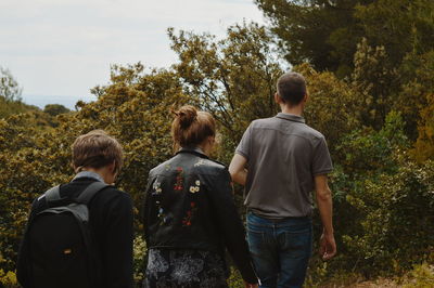 Rear view of people walking on land