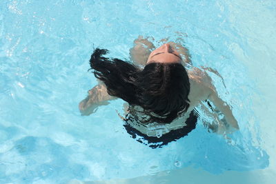 High angle view of woman swimming in pool