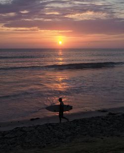 People on beach at sunset