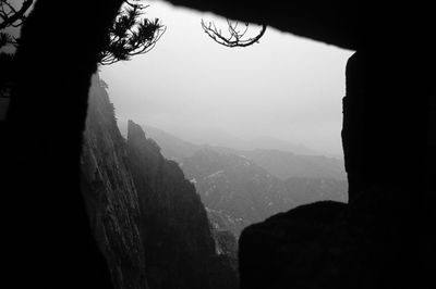 Low angle view of silhouette mountains against sky