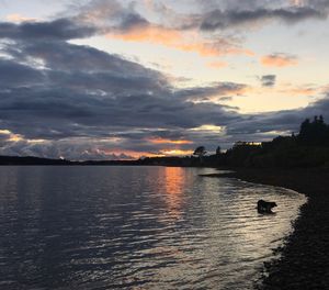 Scenic view of river against sky during sunset