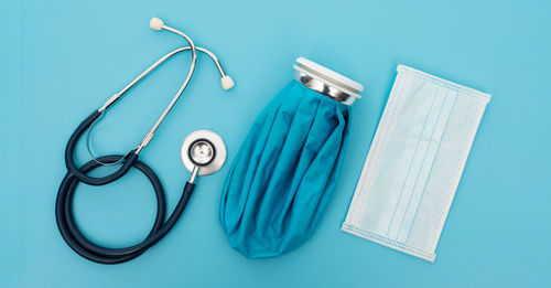 High angle view of eyeglasses on table against blue background