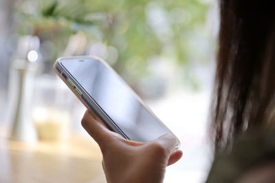 Midsection of woman using mobile phone