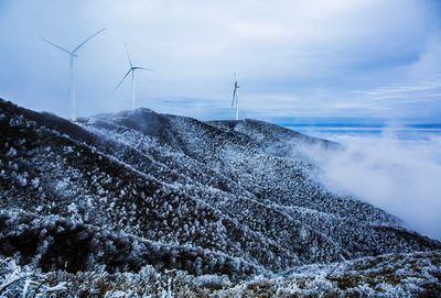 View of windmill on mountain against sky