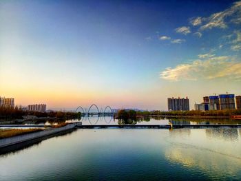 Scenic view of cityscape against sky during sunset