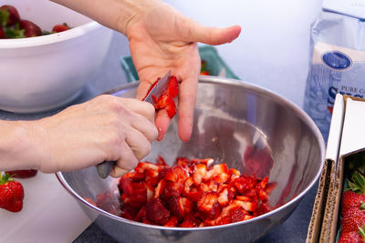 Cropped hand of man preparing food