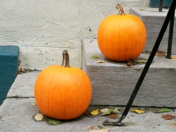 Close-up of orange pumpkins against wall