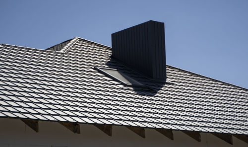 Low angle view of modern building against clear blue sky