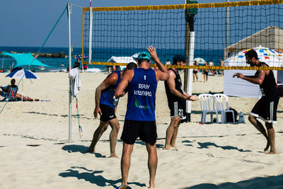 Rear view of people at beach