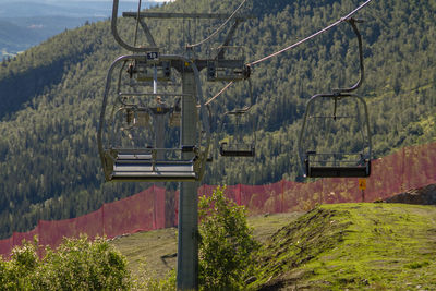 Overhead cable car on landscape against mountains