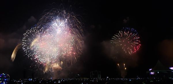 Low angle view of firework display at night