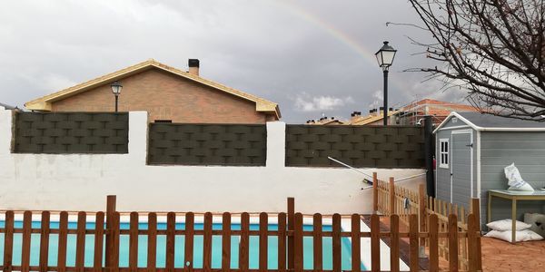 House by building against sky