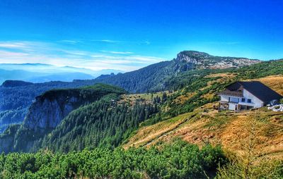 Scenic view of mountain range against blue sky