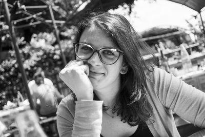 Close-up portrait of woman wearing eyeglasses on sunny day