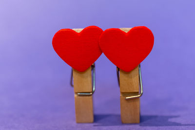 Close-up of heart shape on table against blue background