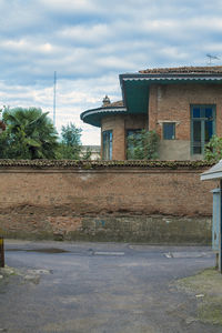 Building by street against sky