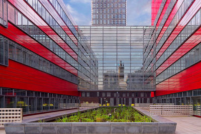 Low angle view of modern building with glass facade reflections and leading lines