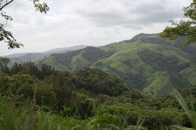 Scenic view of mountains against cloudy sky