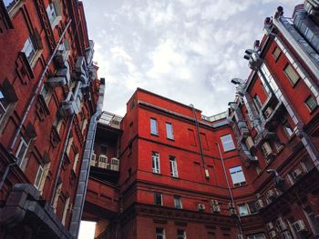 Low angle view of buildings in town against sky