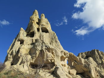 Low angle view of rock formation against blue sky