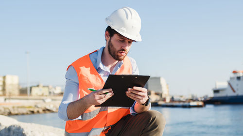 Naval engineer quality check in the port in a city near the ocean