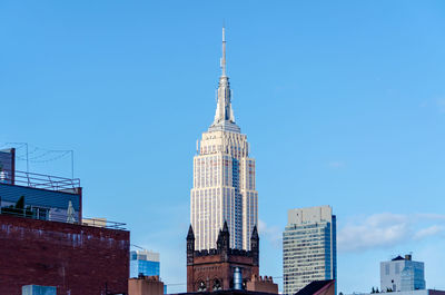 Low angle view of buildings against clear blue sky