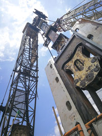 Low angle view of crane against sky