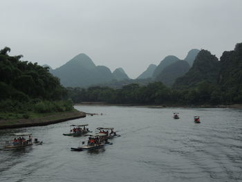 Scenic view of river and mountains against sky