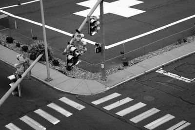 High angle view of road signals by zebra crossing on street