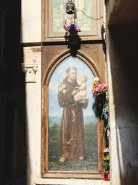 Statue of flower on window of old building